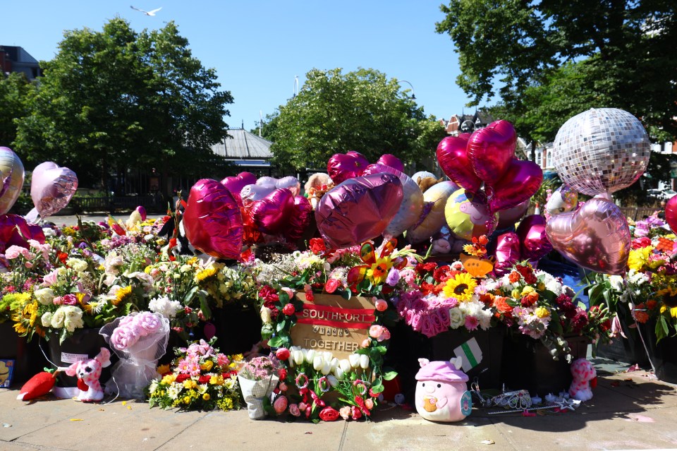 Flowers and balloons left as a tribute to murder victims.