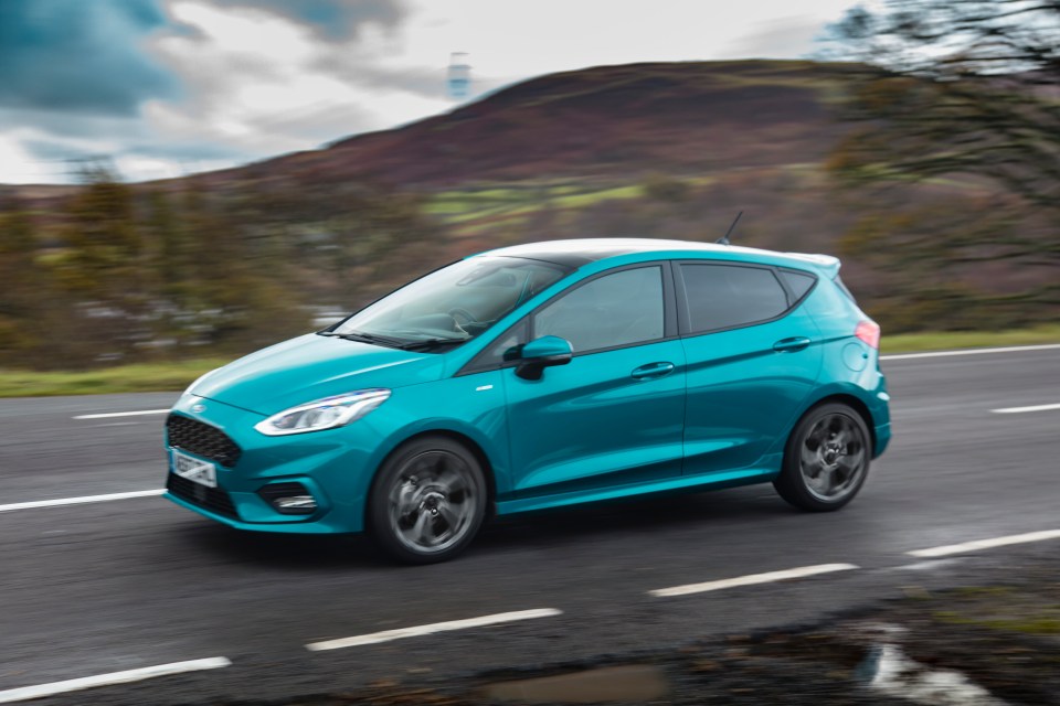 Ford Fiesta driving on a road.