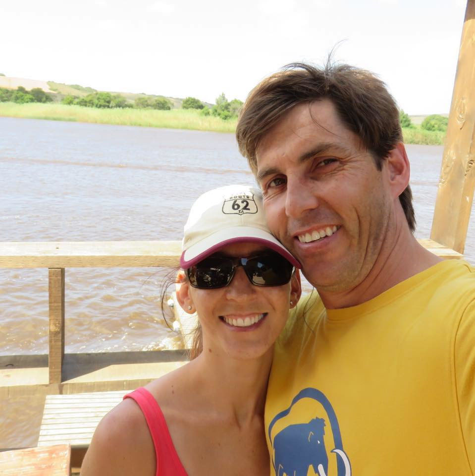 Couple taking a selfie by a river.