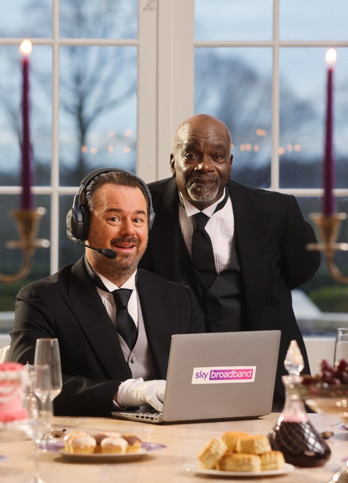 Danny Dyer and Joseph Marcell in butler attire using a Sky Broadband laptop.