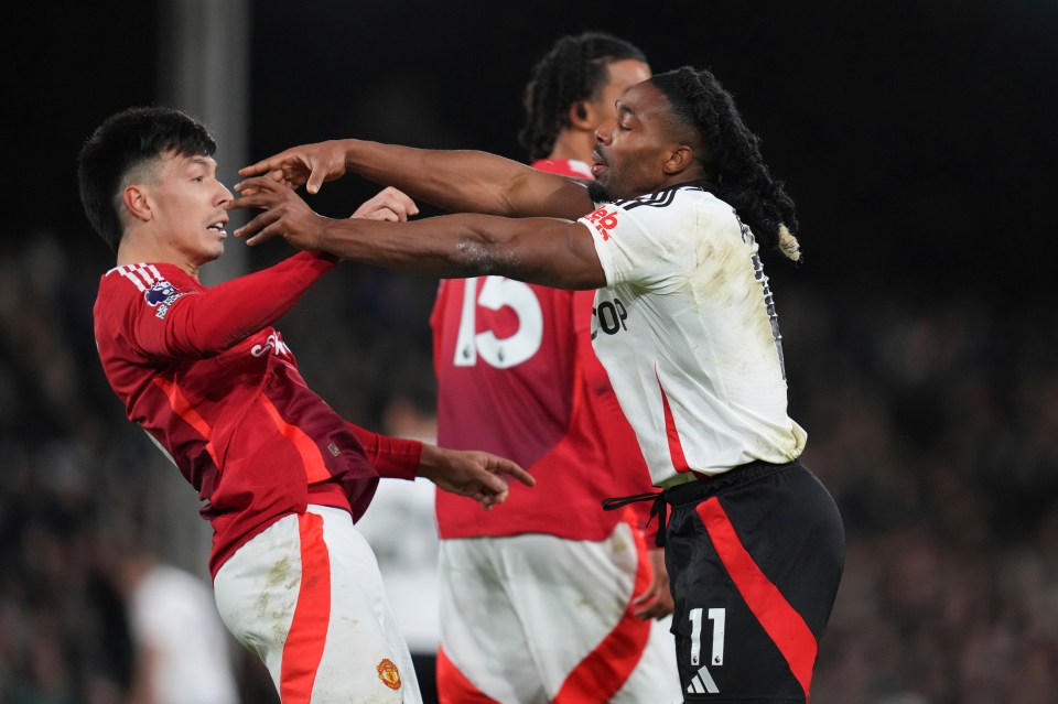 Adama Traore and Lisandro Martinez arguing during a soccer match.