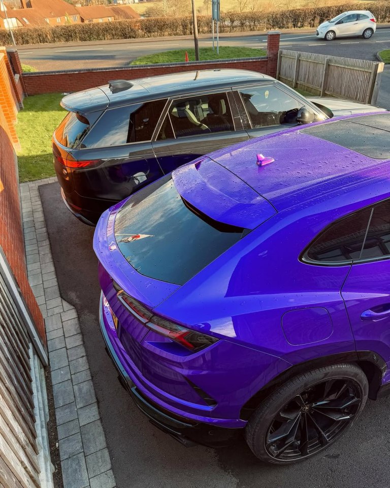 Purple and black SUVs parked in a driveway.