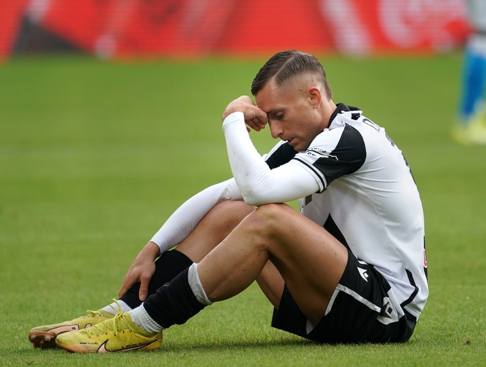 Gerard Deulofeu of Udinese sitting on the field looking distressed.