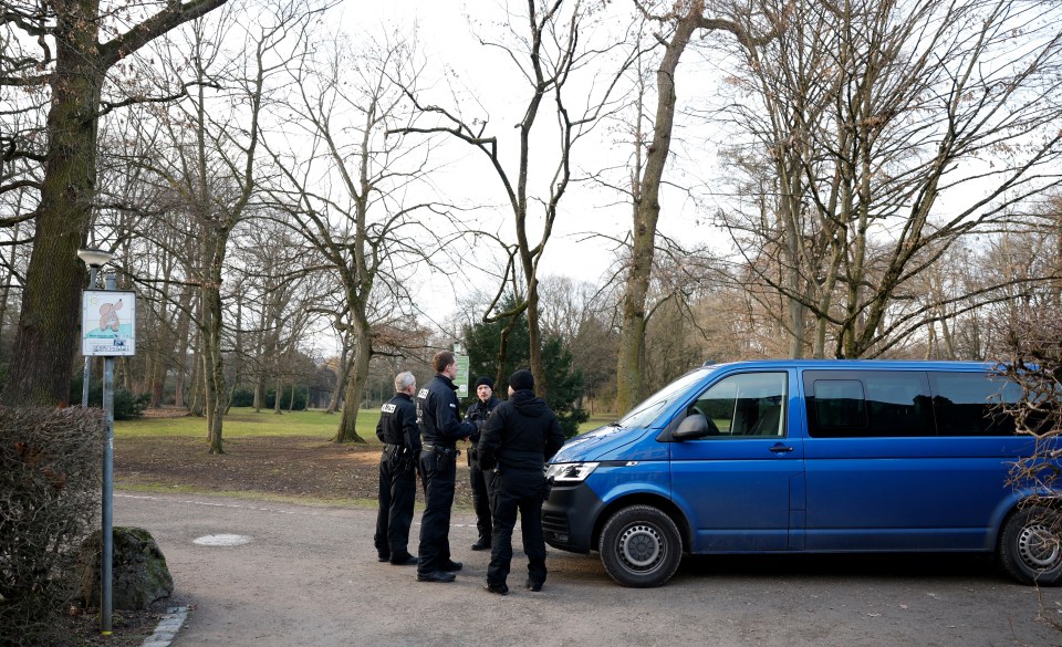 Police officers in a park after a knife attack.