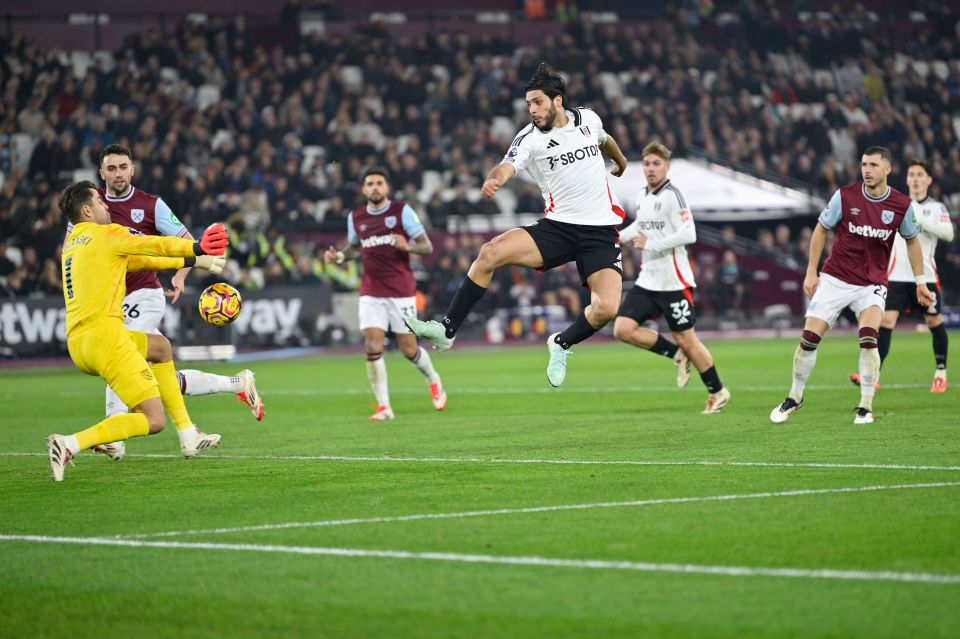 Fulham player scoring a goal against West Ham.