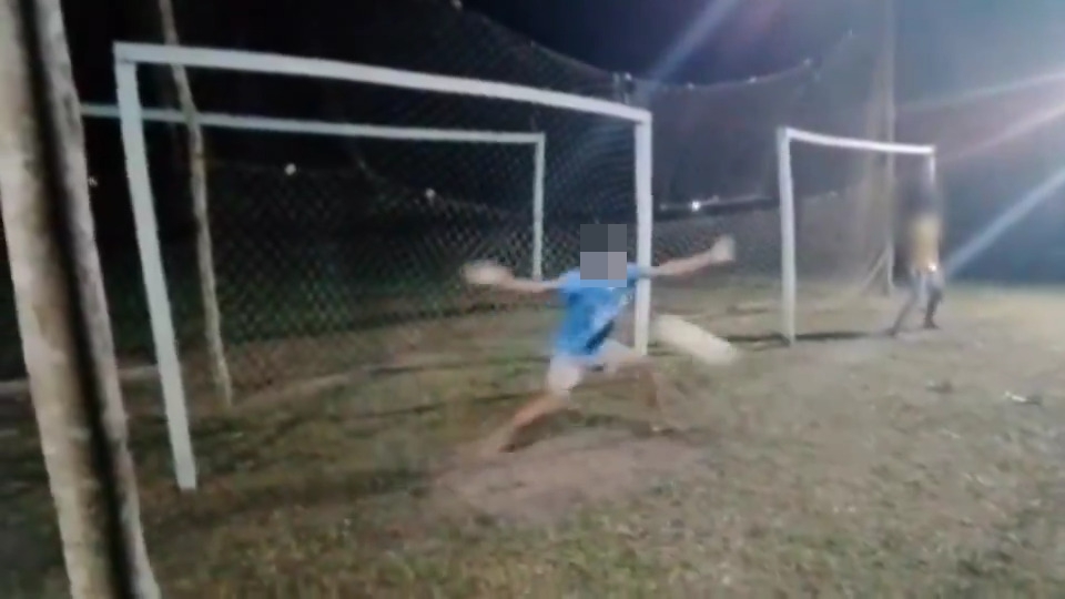 Video still of a soccer goalkeeper saving a penalty kick.