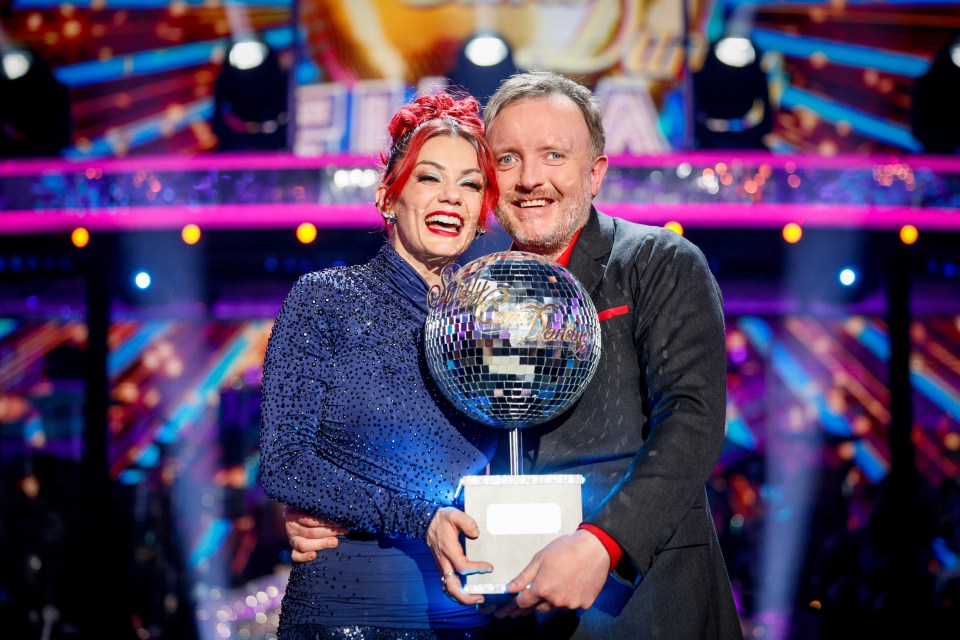 Chris McCausland and Dianne Buswell holding the Strictly Come Dancing glitterball trophy.