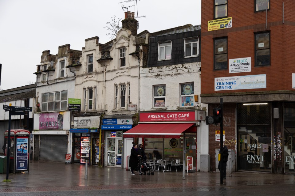 Woolwich street scene with shops and pedestrians.