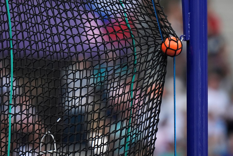 Hammer caught in safety net at Olympic hammer throw.