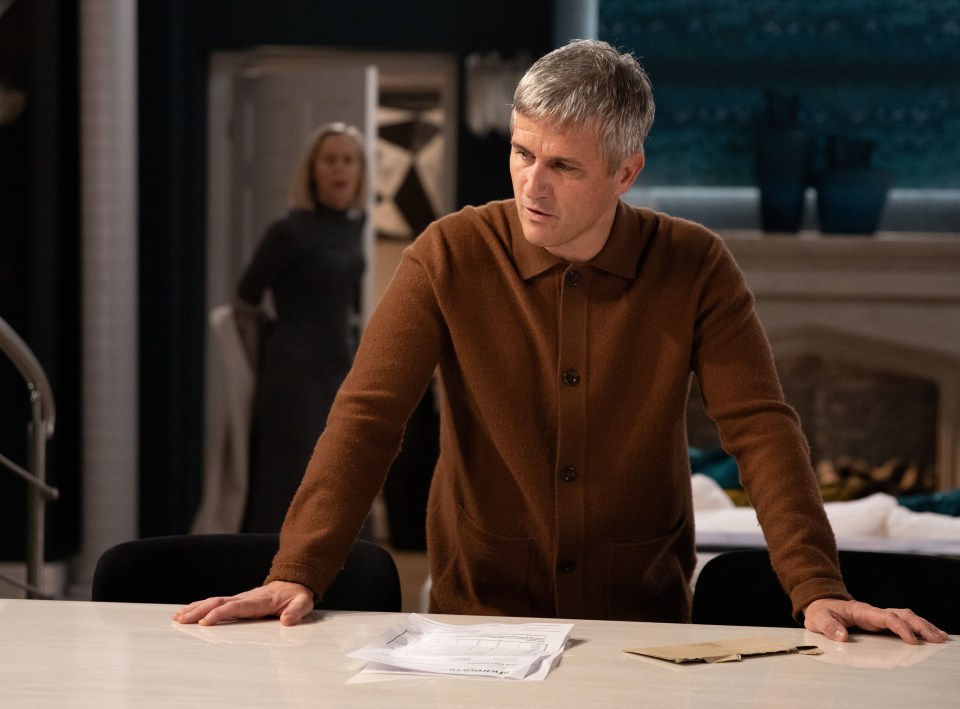 A man looks at a DNA test result envelope on a table.