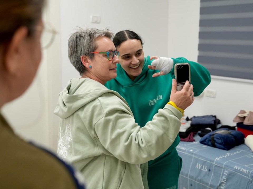 A mother and daughter reunite and take a selfie after the daughter's release from captivity.