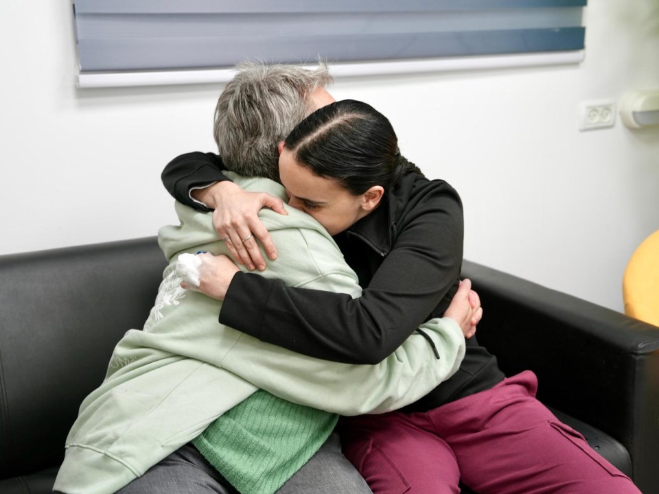 A woman embraces her mother after being released from captivity.