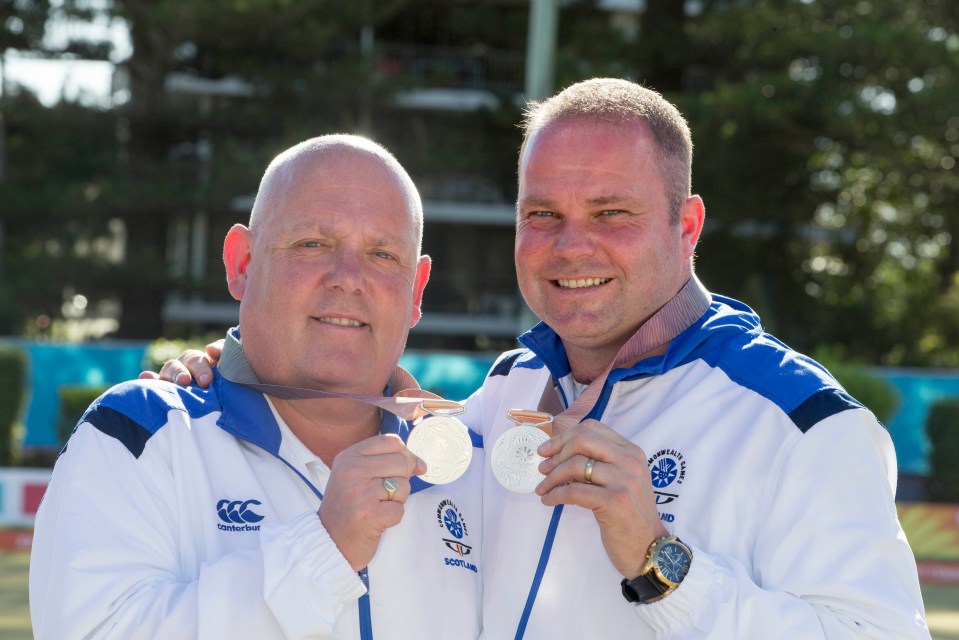 Paul Foster and Alex Marshall, Scottish lawn bowlers, display their silver medals.