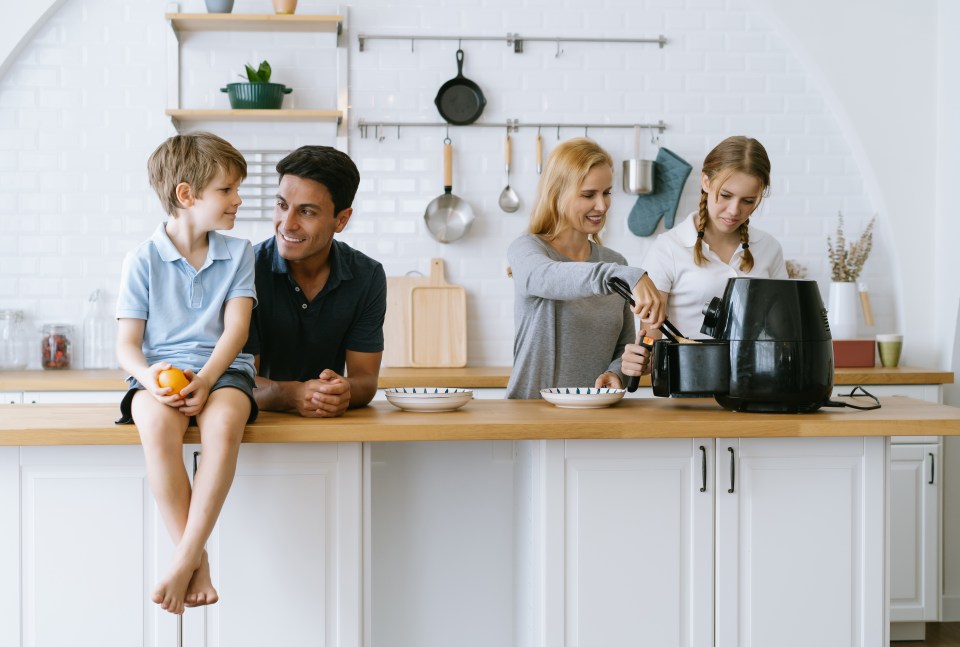 Family preparing breakfast in the kitchen.