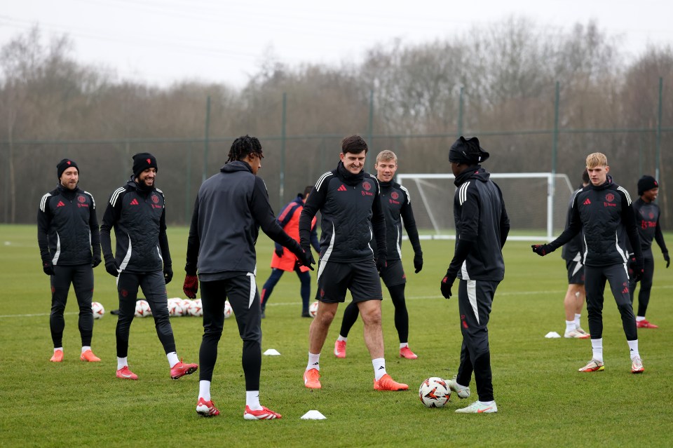 Manchester United players training on a soccer field.