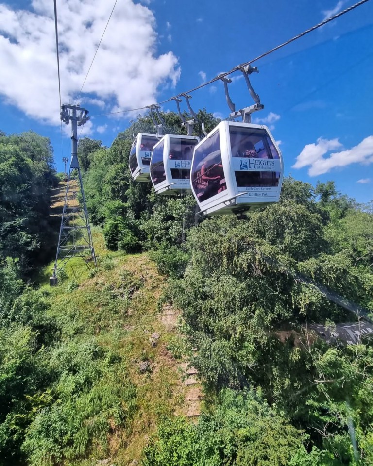 Heights of Abraham cable cars ascending a hillside.