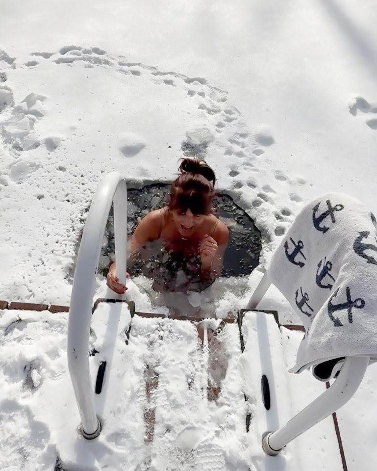 Woman taking an ice dip in winter.