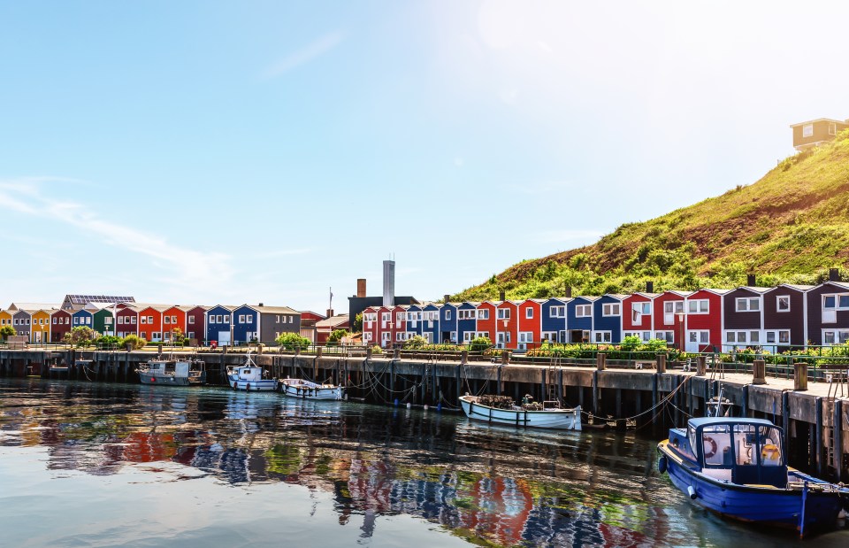 typical colorful houses at waterfront on Helgoland island on sunny day