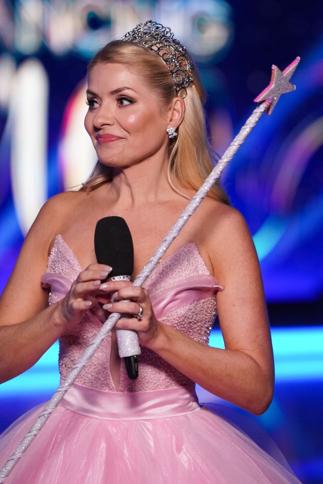 Holly Willoughby on Dancing on Ice, holding a microphone and a sparkly wand.