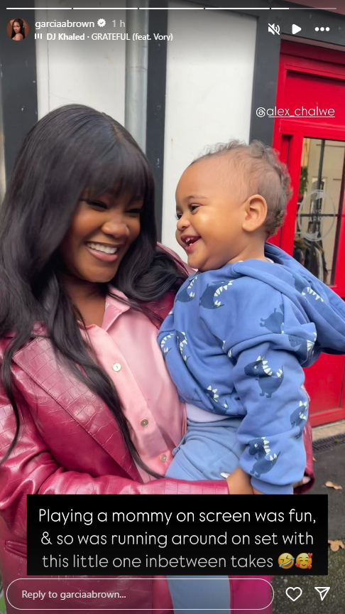 Woman holding a baby on set.