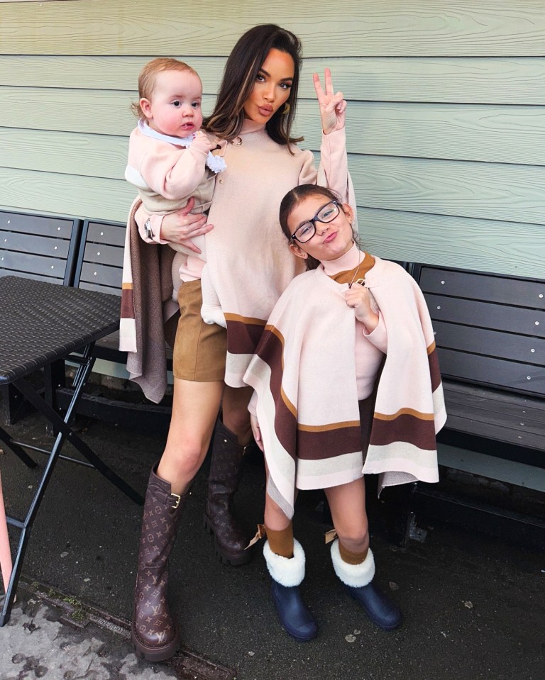 A woman and her two children posing for a Christmas photo.