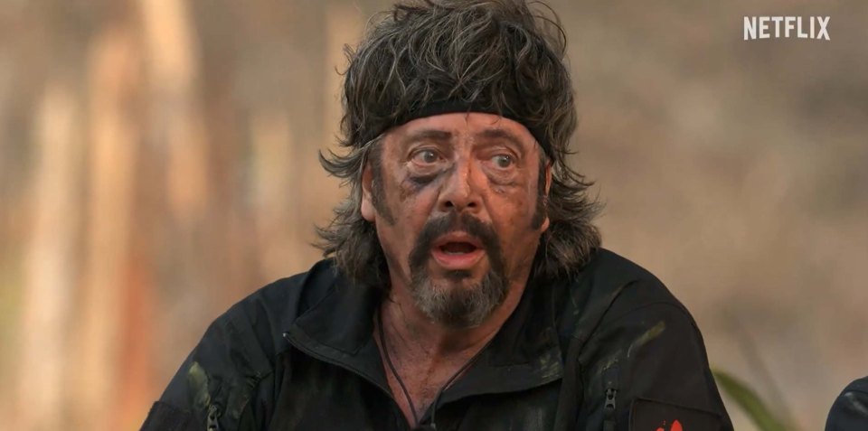 A surprised man with dirt on his face on Celebrity Bear Hunt, hosted by Holly Willoughby on Netflix.