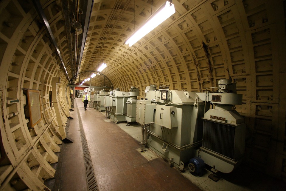 Interior of a London air raid tunnel with electrical equipment.