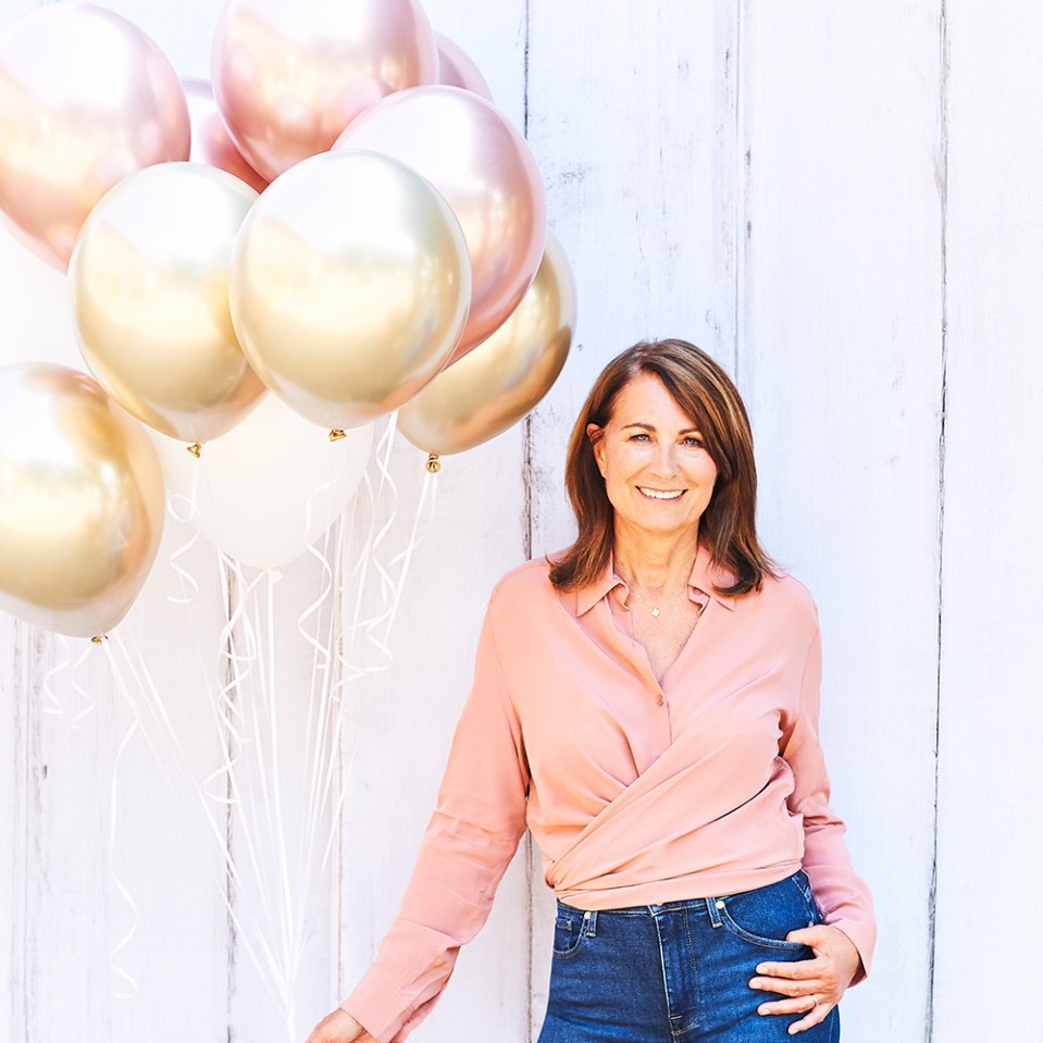 Woman standing with gold and rose gold balloons.