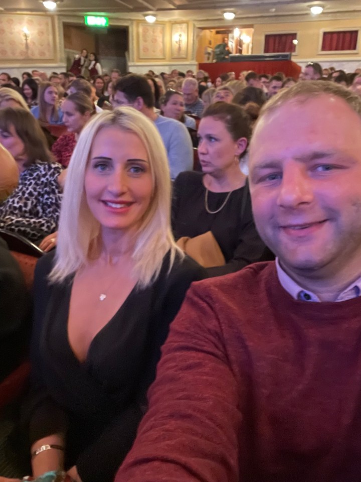 Couple seated in an audience.