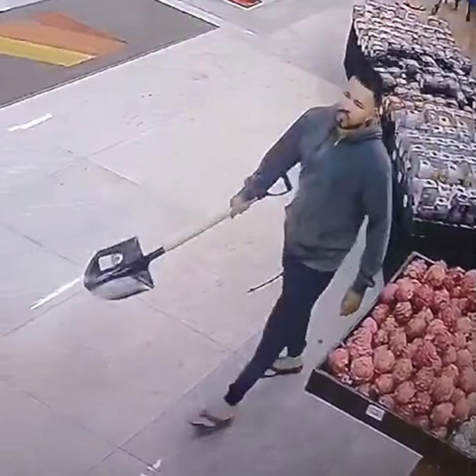 CCTV image of a man holding a shovel in a supermarket.