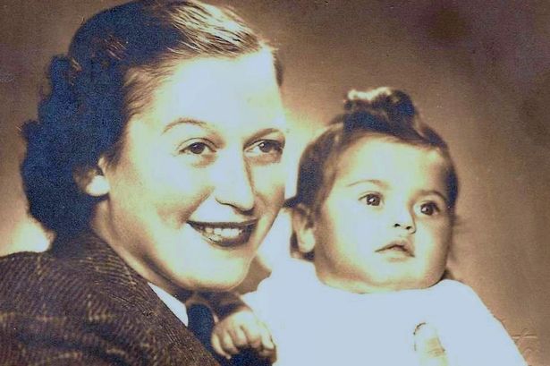 Sepia-toned photo of a mother and her baby, the mother a Holocaust survivor born in a Nazi death camp.