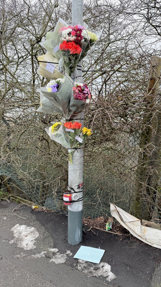 Floral tributes at a roadside memorial.