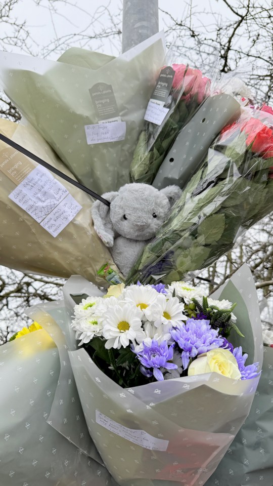 Floral tributes at a roadside memorial.