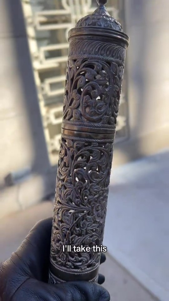 Ornate metal container found in a bin.