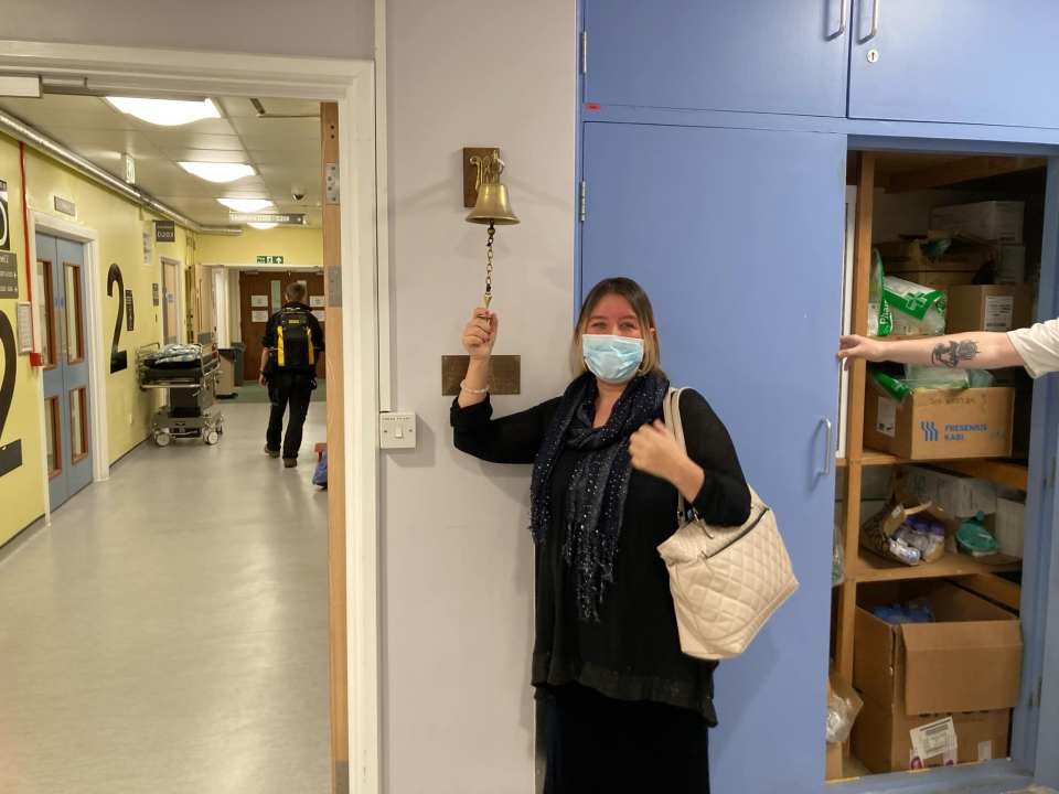 Woman ringing a hospital treatment bell.