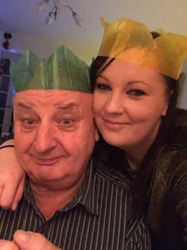 A man and woman wearing paper crowns.