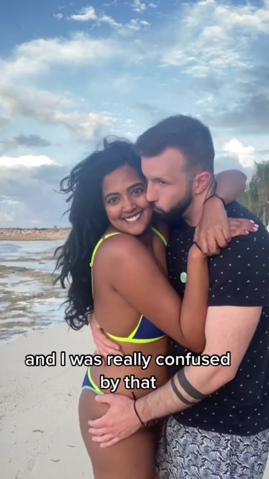 Couple embracing on a beach.