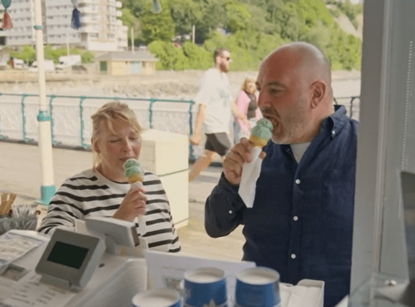 Couple eating ice cream cones.