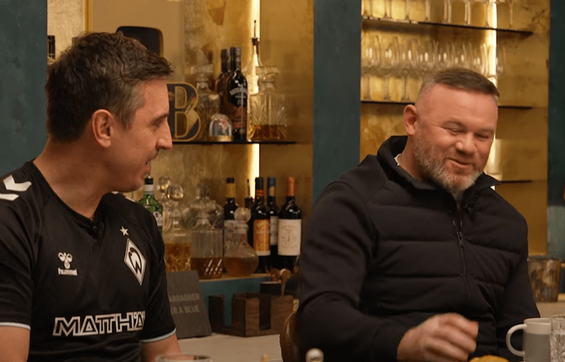 Two men in conversation at a bar.