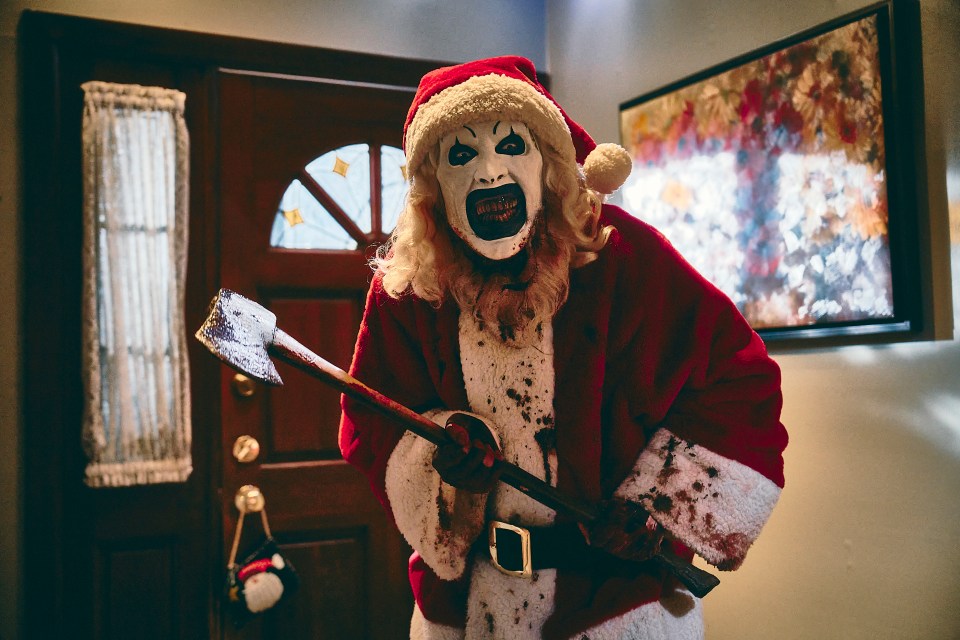 Bloody Santa Claus holding an axe in a scene from "Terrifier 3."