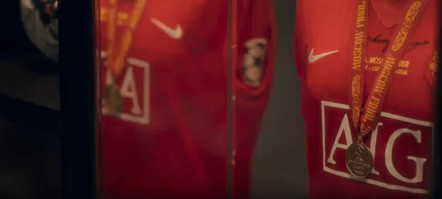 Red soccer jersey with medals.