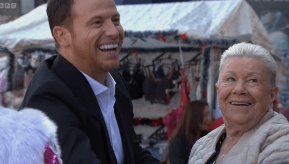 A man and an older woman smiling.