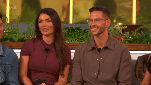 A man and woman smiling and sitting together.