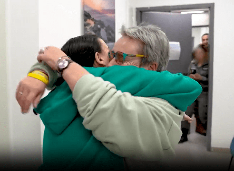 Two people embracing in a hallway.