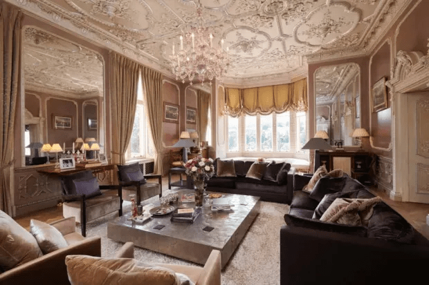 Ornate living room with large sectional sofa and coffee table.