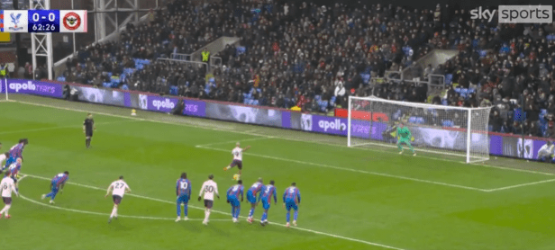 Soccer player taking a penalty kick.