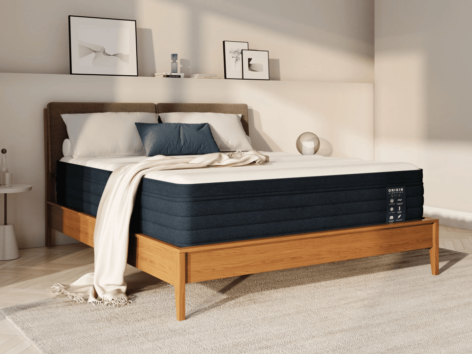 Origin Hybrid Pro mattress on a wooden frame.