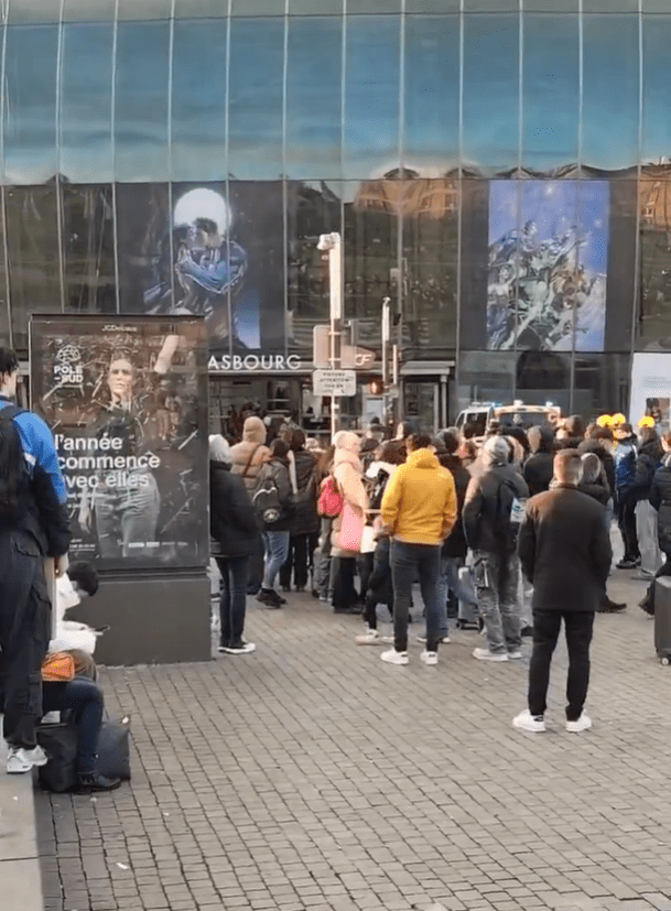 Crowd of people gathered outside a building.