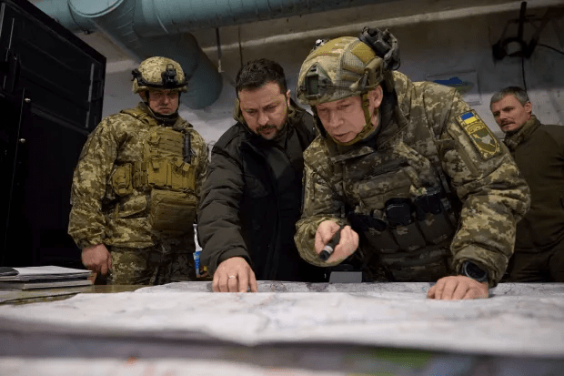 Military officers reviewing a map.