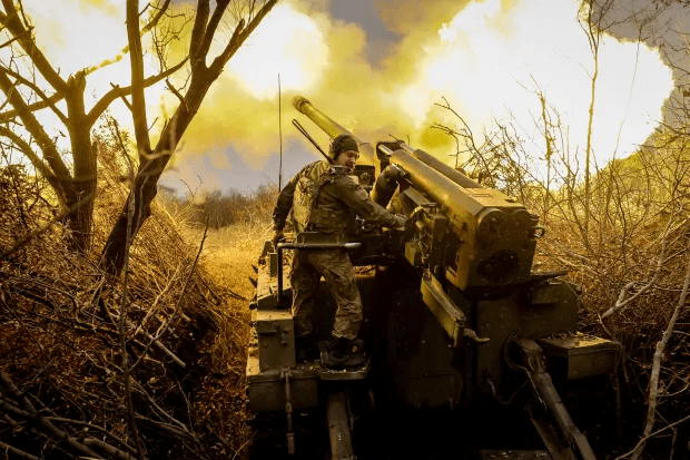 Soldier operating a howitzer.